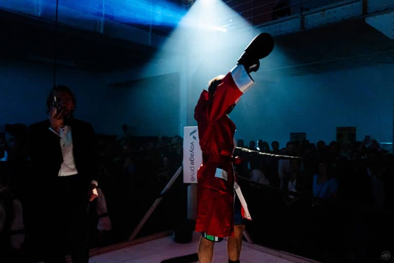 Boxeur vainqueur du combat sur le ring soiree immersive Fight club dans atelier industriel pour Voyage Prive Agence Evenementiel Paris WATO